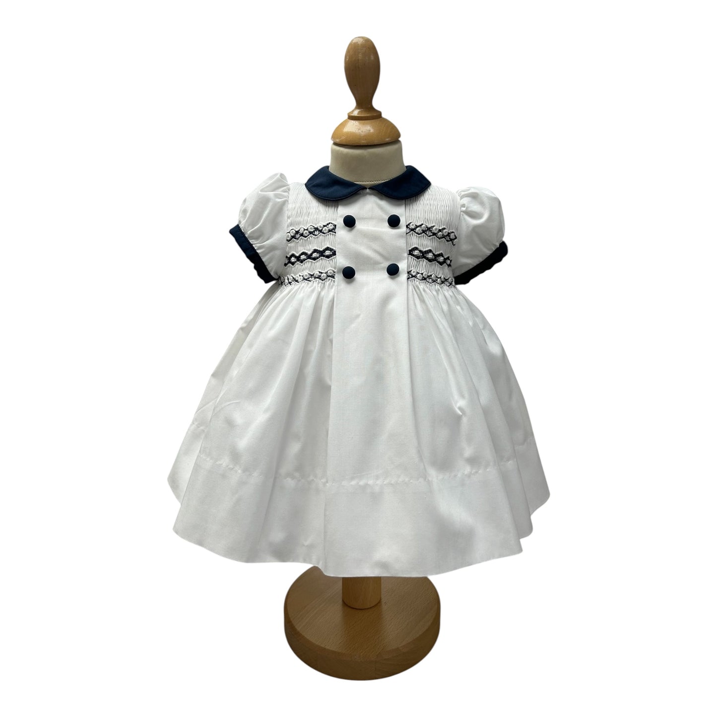 Sarah Louise - Traditional hand smocked white dress with navy trim