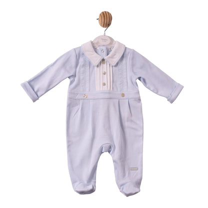 A baby boy's long-sleeve footed romper in light lavender corduroy, featuring a cream-colored faux fur collar and decorative button details on the chest, 