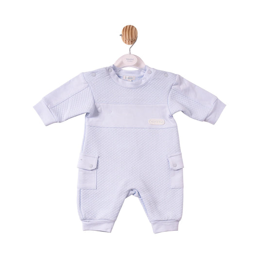 A baby's short-sleeve one-piece romper in a very pale lavender-blue colour, featuring a textured waffle-weave pattern across the chest and legs, side cargo pockets, and a small oval brand patch on the chest.